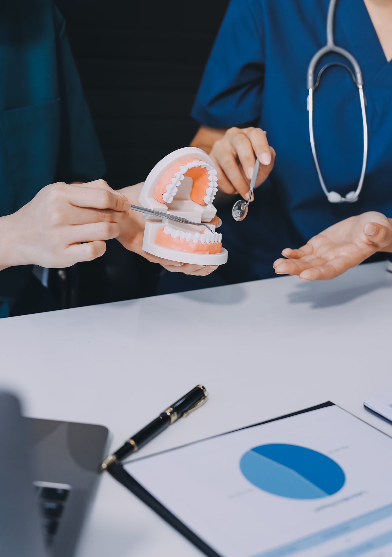 Dental professional demonstrating a denture model